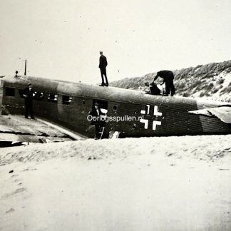 Originele Tweede Wereldoorlog foto van burgers bij het wrak van een neergestort Duits Junkers JU 52 vliegtuig op het strand van Kijkduin / Ter Heijde, mei 1940, tijdens de Duitse inval in Nederland, historisch oorlogsfotografie-object.