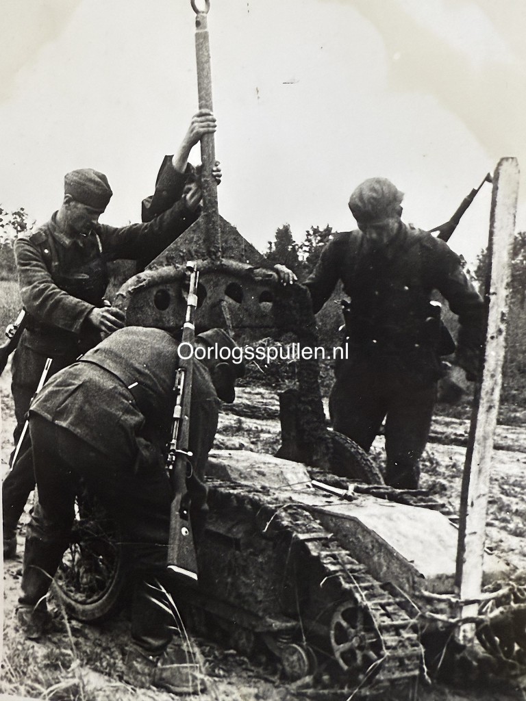 Original WWII German photograph of a Goliath remote-controlled explosive vehicle being prepared by German soldiers in the field, rare Wehrmacht pioneer weapon in action, official German press photo by Kriegsberichter Schlegel-Bregenz dated 22 July 1944, extremely rare Goliath demolition vehicle image, collectible German militaria and military technology photograph, size 18 x 13 cm.