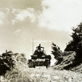 Original WWII German photograph of a German Panzer operating in rugged mountainous terrain during anti-partisan operations, rare Wehrmacht armored vehicle in action, official German press photo by Kriegsberichter Przibilla dated 29 July 1944, authentic Balkan anti-partisan Panzer scene, collectible German armored warfare photography, size 18 x 13 cm.