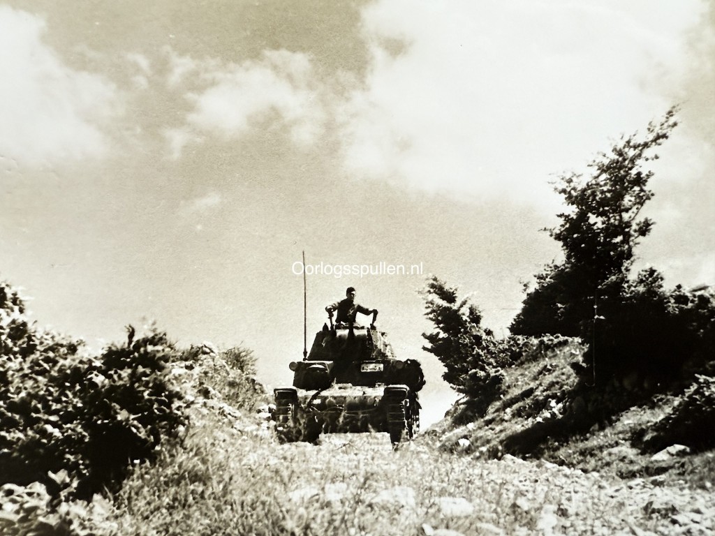 Original WWII German photograph of a German Panzer operating in rugged mountainous terrain during anti-partisan operations, rare Wehrmacht armored vehicle in action, official German press photo by Kriegsberichter Przibilla dated 29 July 1944, authentic Balkan anti-partisan Panzer scene, collectible German armored warfare photography, size 18 x 13 cm.