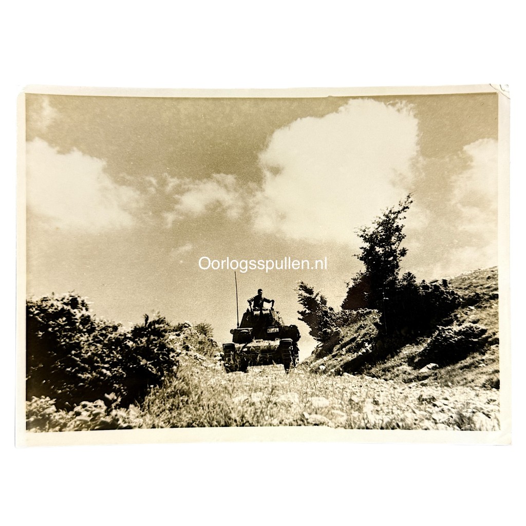 Original WWII German photograph of a German Panzer operating in rugged mountainous terrain during anti-partisan operations, rare Wehrmacht armored vehicle in action, official German press photo by Kriegsberichter Przibilla dated 29 July 1944, authentic Balkan anti-partisan Panzer scene, collectible German armored warfare photography, size 18 x 13 cm.