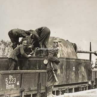 Original WWII German photograph of a camouflage-painted Panther tank on a railway flatcar, German soldiers inspecting and working on the tank during transport, late-war Wehrmacht armored scene, official German press photo by Kriegsberichter Kocherber dated 3 July 1944, rare Panther tank railway transport image, collectible German militaria photo, size 18 x 13 cm.