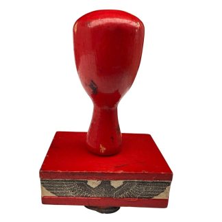 Authentic WWII German wooden stamp with Nazi eagle and swastika, red lacquered handle, original Third Reich administrative stamp, rare militaria collectible for World War II collectors and historical archives.