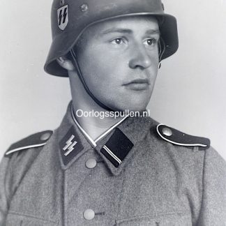 Unpublished World War II glass negative featuring a studio portrait of a young Waffen-SS soldier in full uniform with helmet and SS collar tabs, highly detailed original wartime military photograph on glass, rare WWII German military photography collectible for historians and militaria collectors.