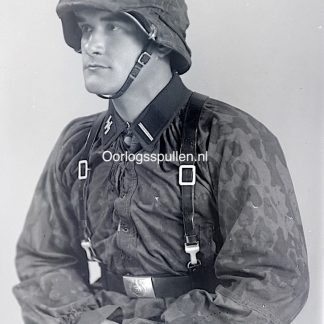 Unpublished World War II glass negative showing a Waffen-SS soldier in camouflage uniform with camouflage helmet cover, detailed studio portrait with SS collar tabs, combat gear and straps visible, rare original WWII German Waffen-SS military photography collectible for advanced collectors and historians.