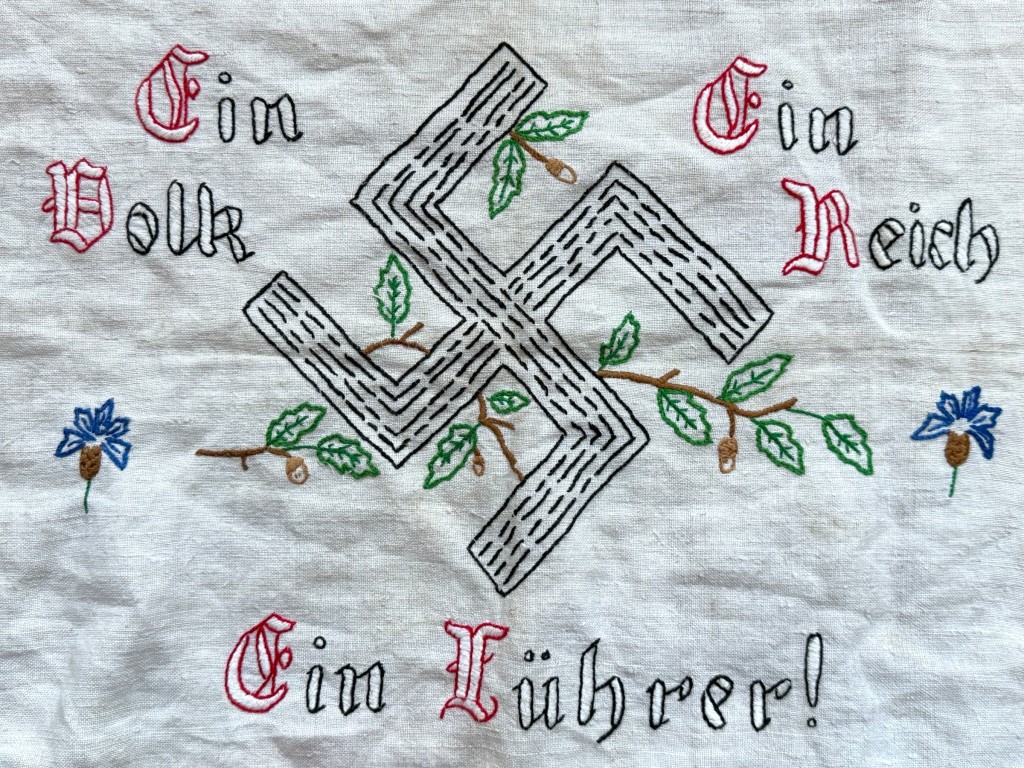 Authentic 1930s German embroidered pillowcase featuring oak leaves and the slogan “Ein Volk, Ein Reich, Ein Führer.” Original Nazi-era household textile, ideal for WWII militaria collectors, museums, and historical study. 56 × 40 cm.