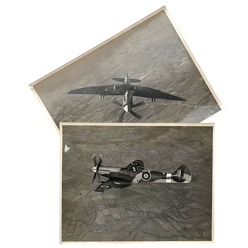 Original WWII British RAF Supermarine Spitfire Mk XII large format press photographs 24 x 18 cm, in-flight aerial views over England, elliptical wings and RAF roundels visible, Vickers-Armstrongs factory stamp and photographer Chas E Brown credit on reverse, authentic World War II Royal Air Force fighter aircraft images, rare collectible for WWII RAF aviation memorabilia collectors.