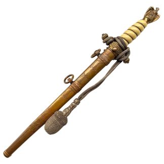 WWII German Kriegsmarine officer dagger with gilt brass scabbard, engraved lightning and foliage motifs, eagle pommel with wreath and swastika, ivory-tone grip with wire wrap and original portepee knot – rare Third Reich naval militaria collectible.
