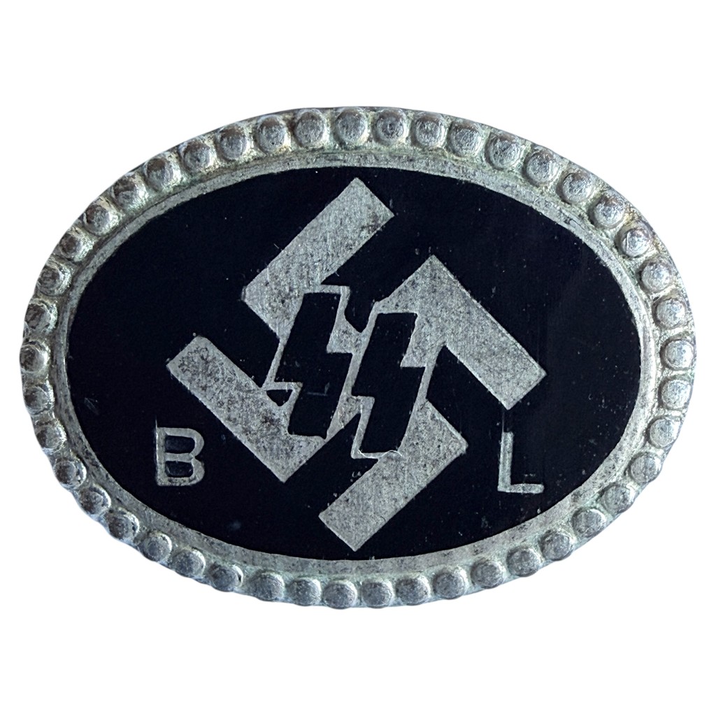 Original WWII Dutch SS “Begunstigde Leden (BL)” enamel membership pin, featuring black oval enamel, SS runes, and silver beaded border – rare Netherlands SS supporter badge highly desirable for advanced WWII militaria collectors.