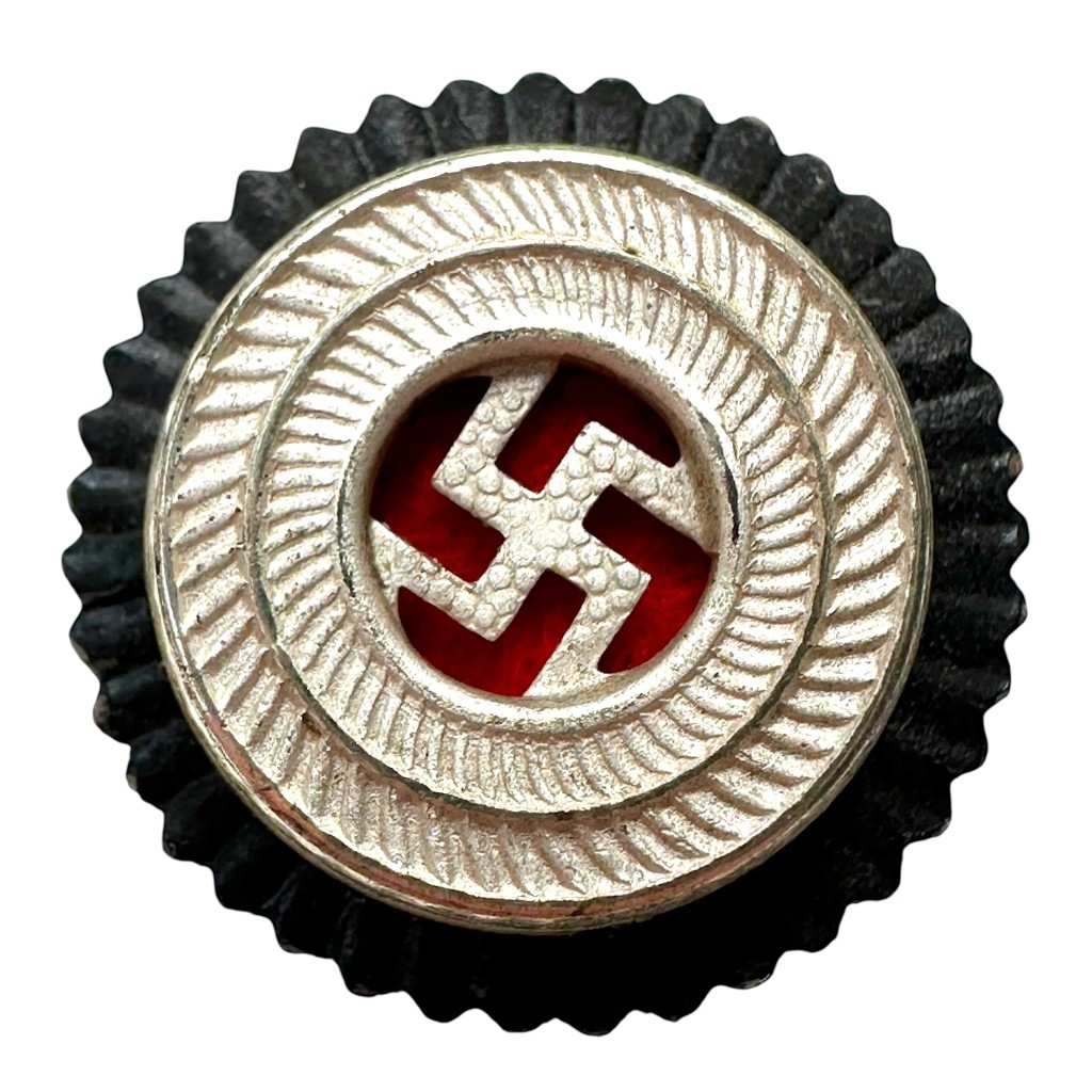 Original WWII German NSDAP visor cap cockade, swastika party badge with silver wreath and black backing – authentic Third Reich cap insignia for advanced militaria collectors.