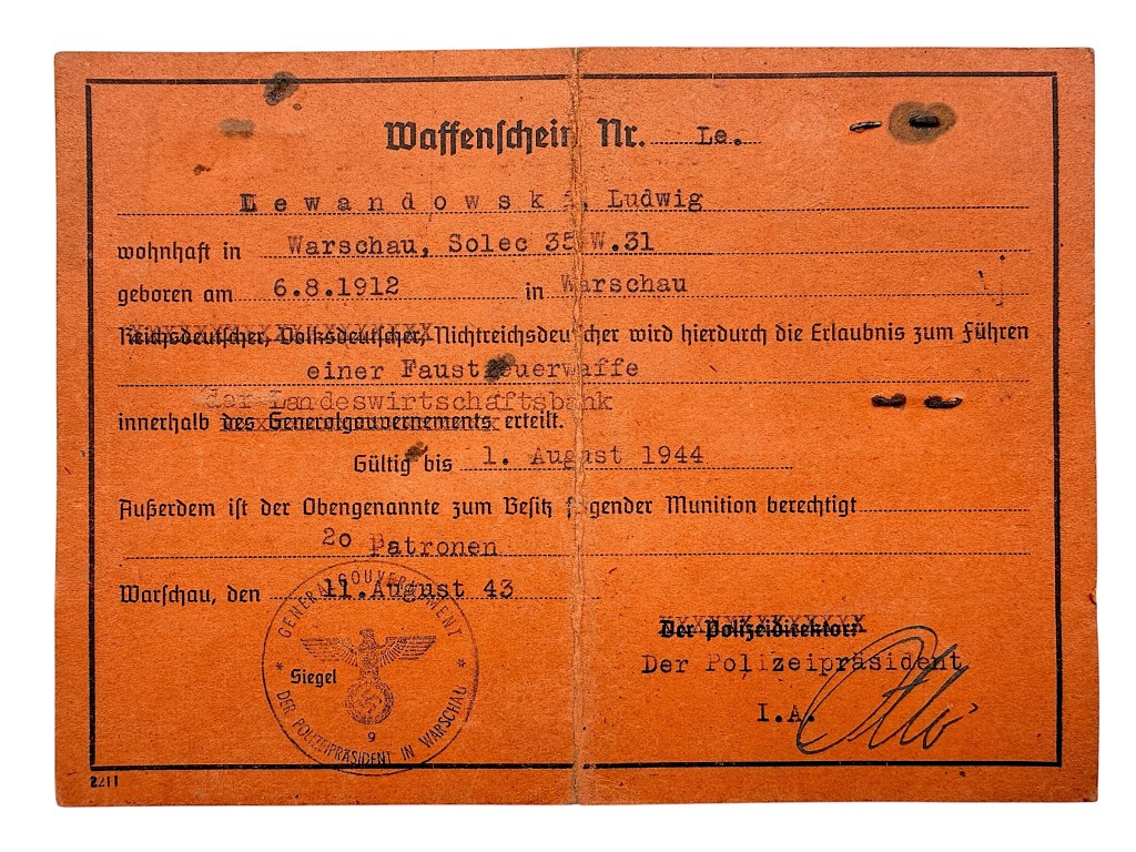 Interior of German WWII Waffenschein issued in Warsaw 1943 with personal details and official Nazi police stamp
