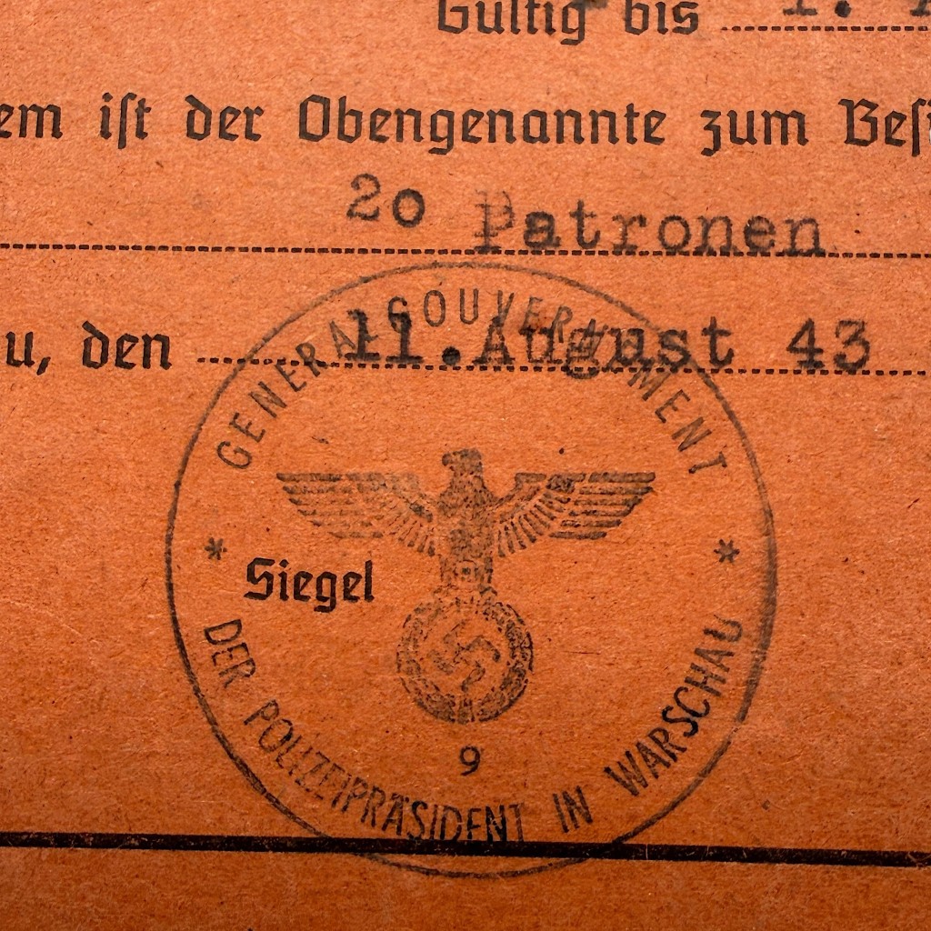 Close up Generalgouvernement police seal with eagle and swastika on WWII German weapons permit document