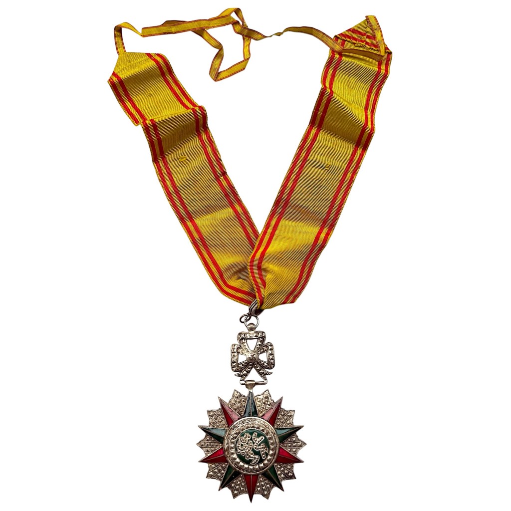 Original Tunisian Nichan Iftikhar Commander’s Cross with enamelled star and neck ribbon from the Beylik of Tunis and French Protectorate.