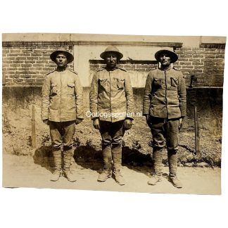 Original WWI German Army photo showing three captured Portuguese soldiers in uniform and steel helmets on the Western Front during World War I.