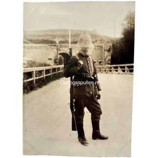 Original WWI German Army photo soldier wearing mosquito protective net with rifle and bayonet on the swampy Eastern Front.