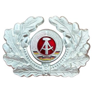 Originele DDR NVA kokarde met eikenloofkrans voor Schirmmütze vizierpet Koude Oorlog Oost-Duitse militaria.