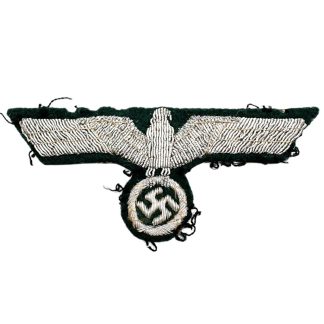 Original WWII German Heer officer breast eagle Brustadler bullion embroidered in silver-colored metal thread on dark green uniform cloth.