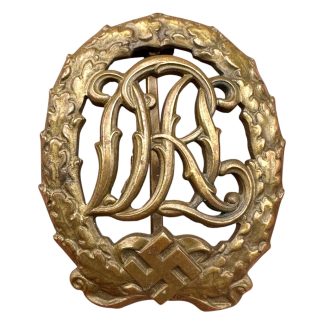 Original WWII German DRL Sports Badge in Bronze with oak leaf wreath and swastika, maker marked Wernstein Jena and DRGM 35269.