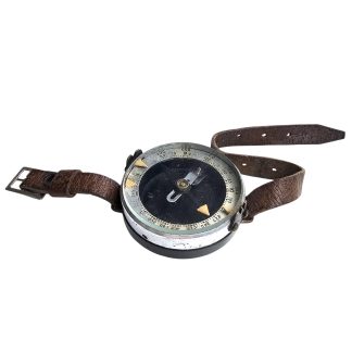 Original WWII Soviet Russian Red Army 1940 wrist compass with Cyrillic dial, graduated navigation scale and original brown leather wrist strap.